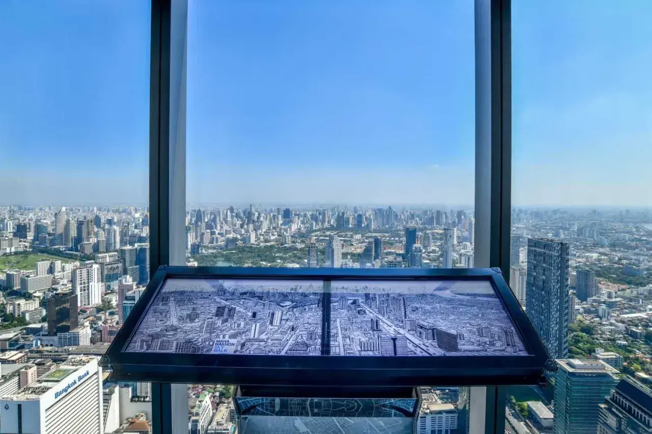 Blick vom Mahanakhon Skywalk auf Bangkok. Eine Karte der Stadt liegt auf einem Tisch.