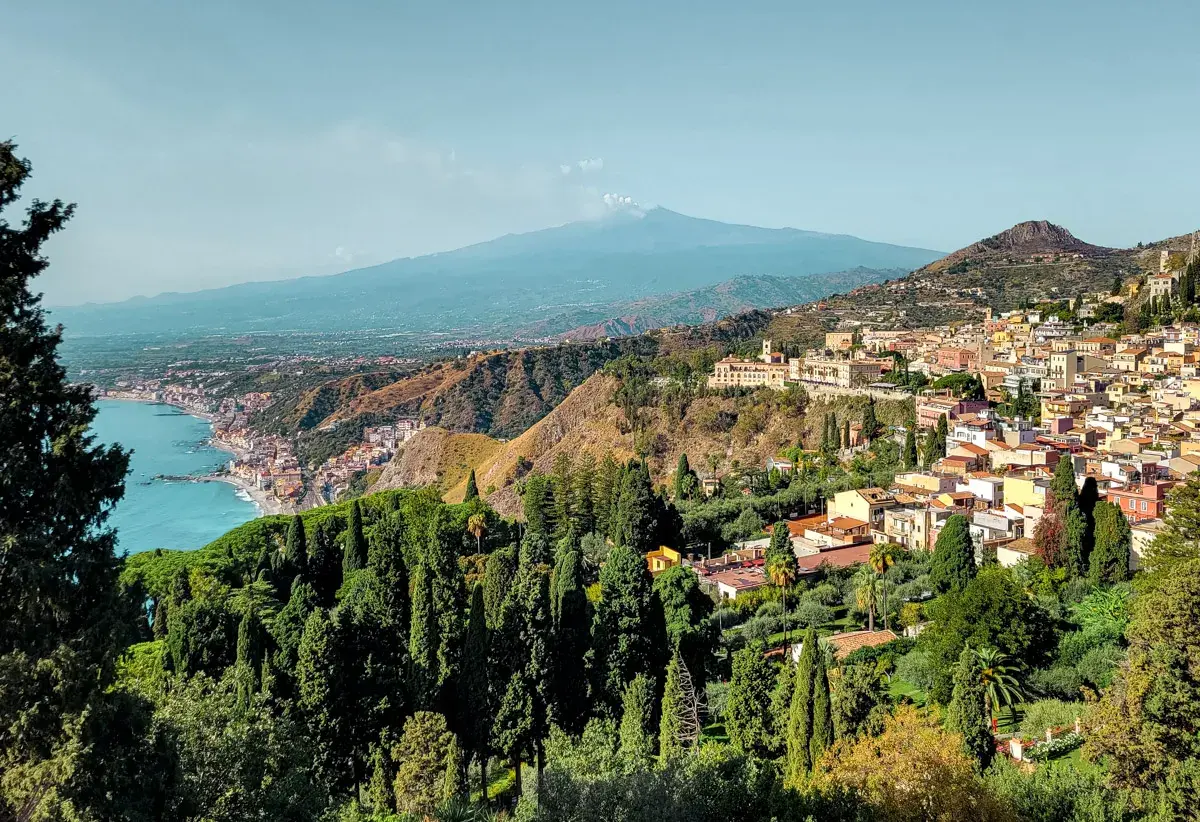 A stunning view of Taormina, Sicily, with Mount Etna in the distance. Perfect for a 14-day Sicily itinerary.