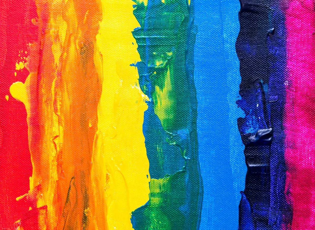 Thick, textured paint strokes in red, orange, yellow, green, blue, and pink demonstrate what is color theory in art, showing how colors interact.