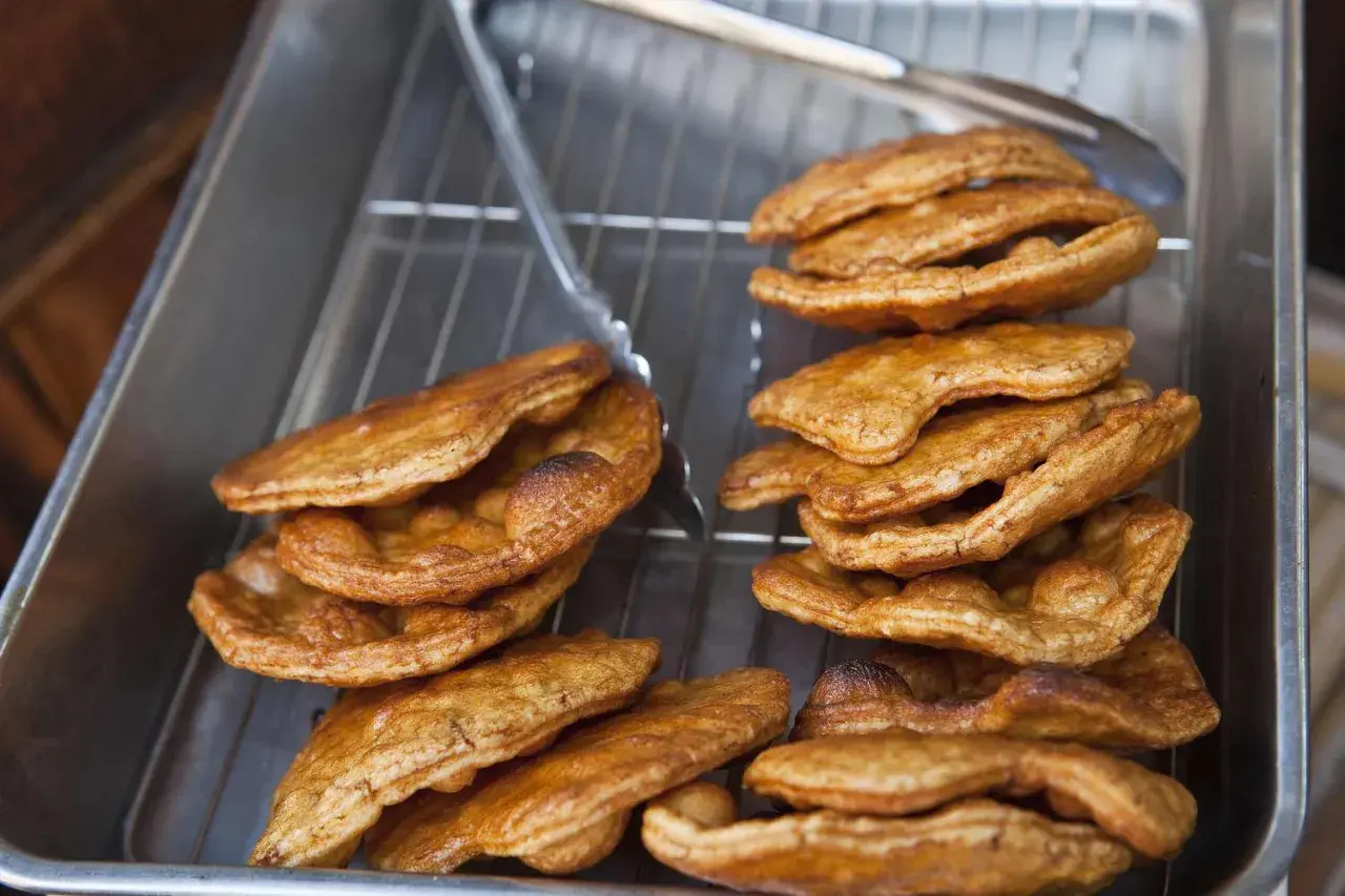 Golden brown, freshly fried Japanese rice crackers cooling on a rack. This image captures the essence of a delicious Japanese rice crackers recipe.