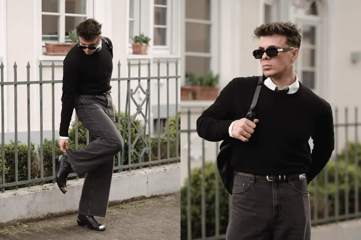 Mann in schwarzem Pullover, weißem Hemd und dunkler Hose, bereit für ein Techno-Festival. Coole Sonnenbrille und Stiefel runden den Look ab.