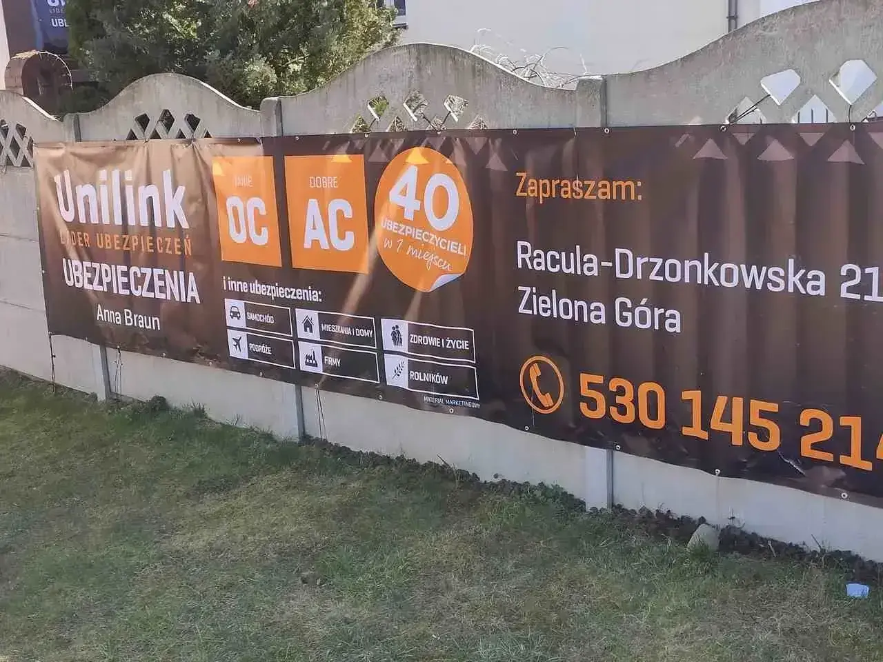 Baner reklamowy Unilink z ofertą ubezpieczeń OC, AC, samochodowych, mieszkaniowych, podróży, firmowych i rolniczych w Zielonej Górze.