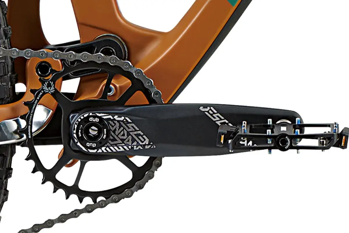 Close-up of a bike's crankset and chainring, showing the DUB bottom bracket and pedal.