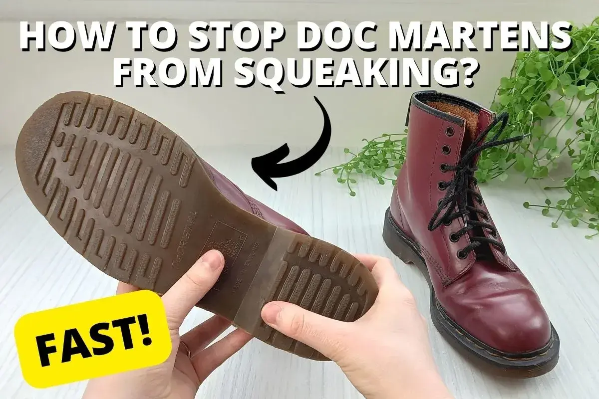 Hands hold a burgundy Doc Marten boot, showing its sole. A second boot sits nearby. Learn why are my boots squeaking when I walk and how to fix it FAST!