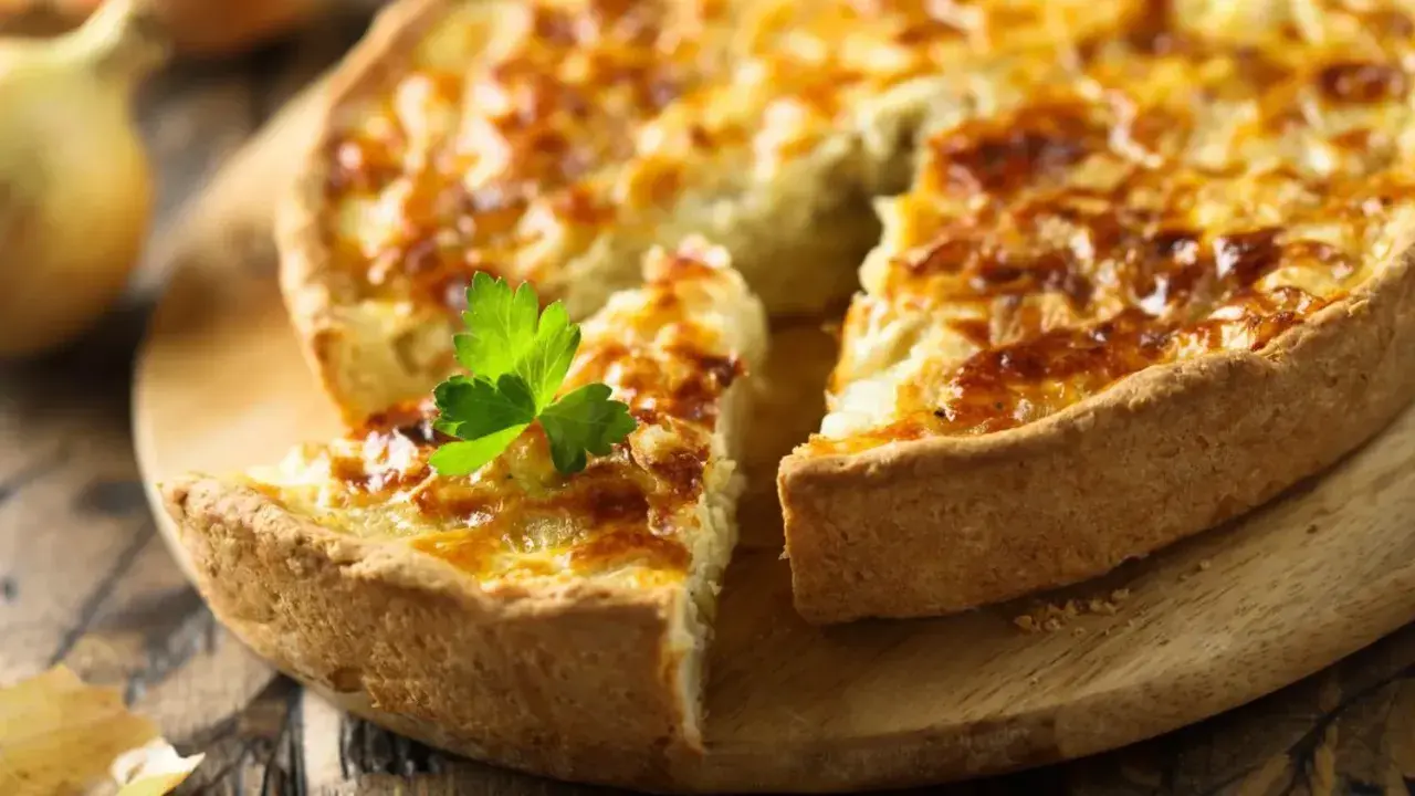 Une quiche dorée, garnie de persil, prête pour la conservation au frigo. Parfaite pour un repas rapide.