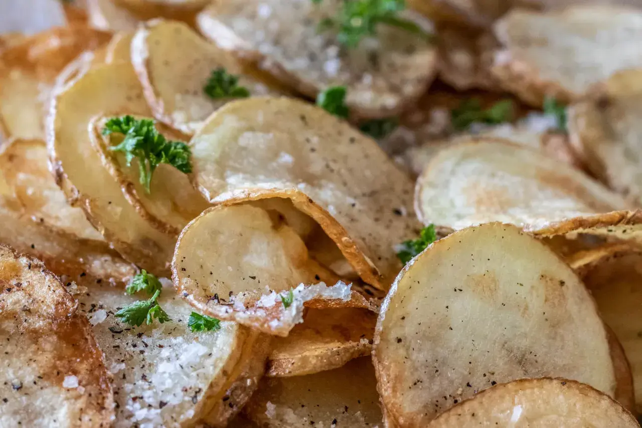 Krispiga, gyllene pommes frites, strödda med salt och peppar, toppade med färsk persilja. En perfekt sidorätt.