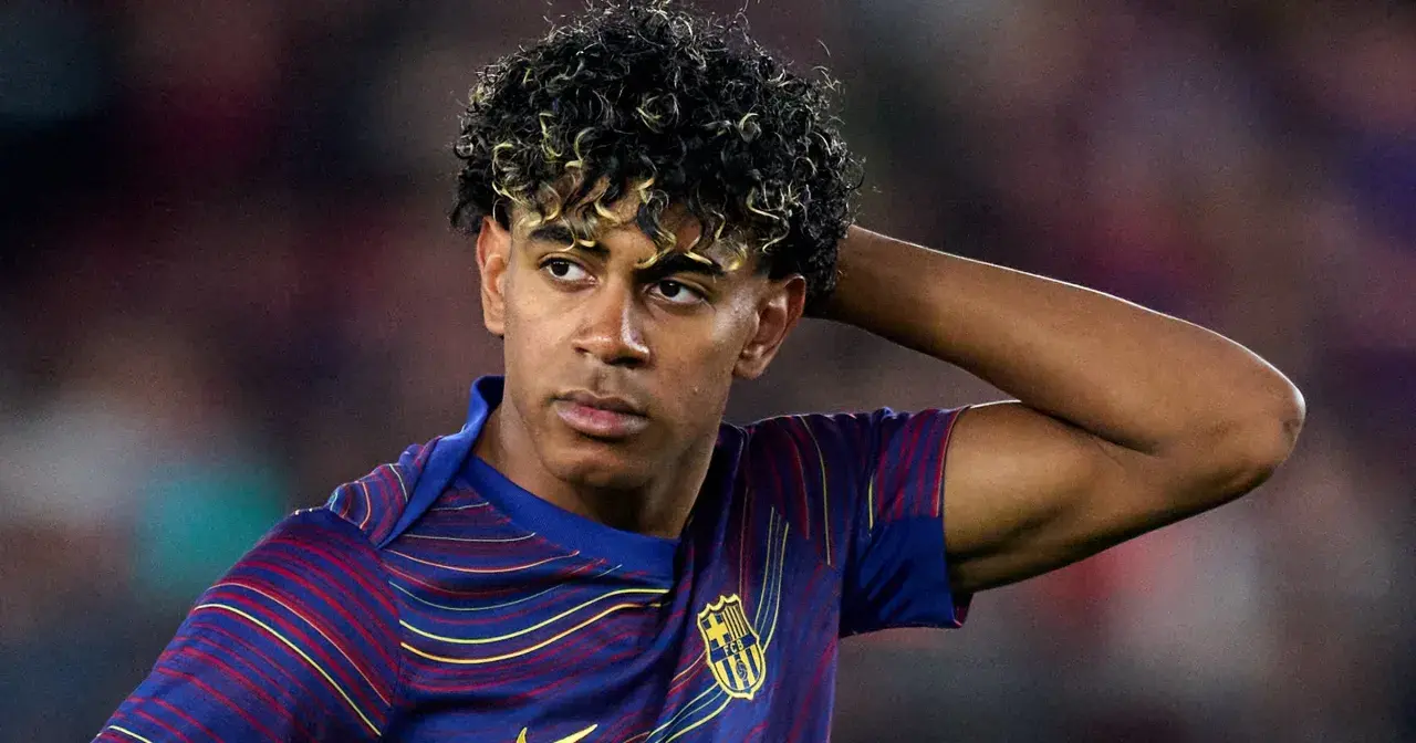 Lamine Yamal z FC Barcelony, zmartwiony po kontuzji, trzyma rękę za głową.