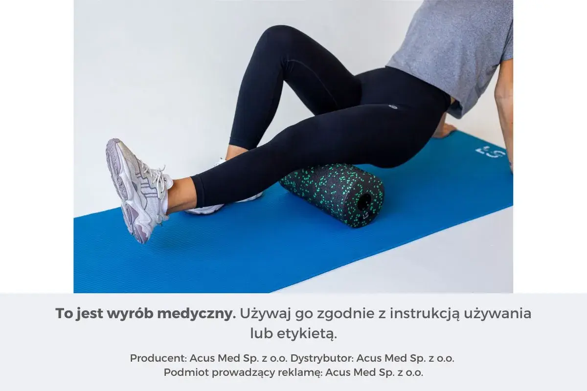 Kobieta wykonuje rolowanie przywodzicieli na macie z użyciem czarnego rollera z zielonymi kropkami.