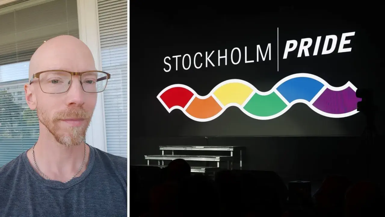 Man med glasögon och skägg framför en skärm med texten STOCKHOLM PRIDE och en regnbågsfärgad våg.