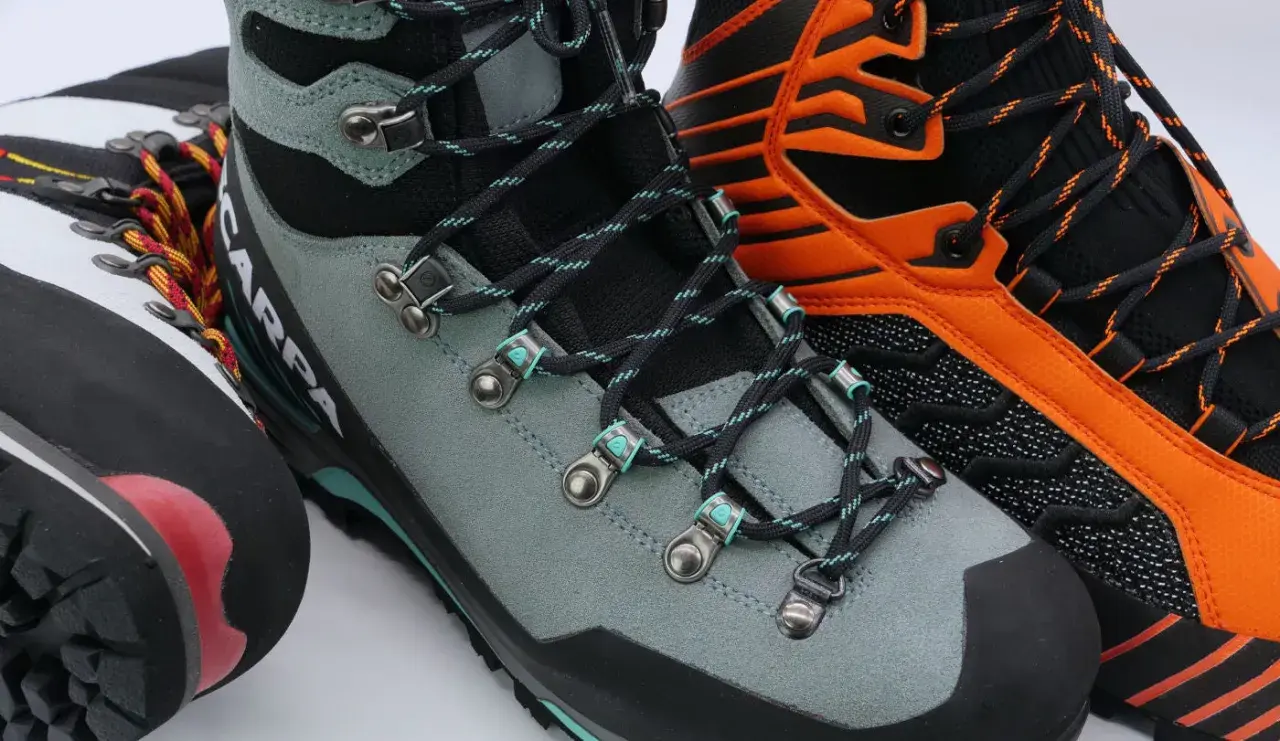 Close-up of three pairs of mountaineering boots, showing lacing details. Learn how to fit mountaineering boots for your next adventure.