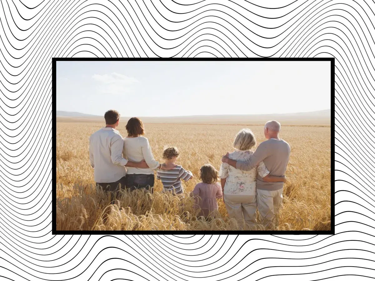 Una familia de tres generaciones en un campo de trigo, unida por el amor y las **frases de familia** que los unen.
