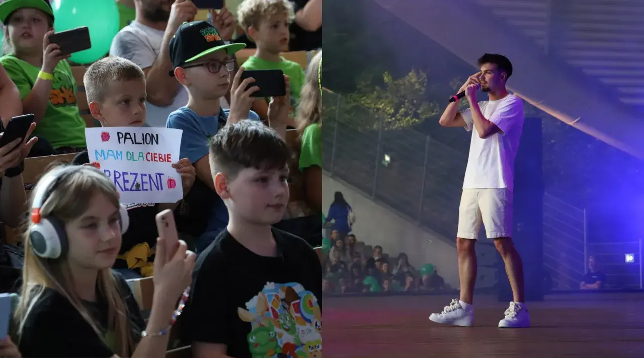 Dzieci na koncercie, jedno z nich trzyma transparent "PALION mam dla ciebie prezent". Na scenie artysta.