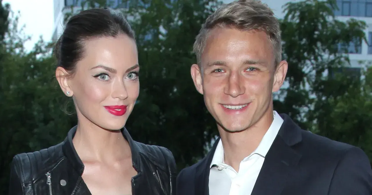 Edyta Zając i Jakub Rzeźniczak uśmiechają się do obiektywu. Ona w skórzanej ramonesce i z mocnym makijażem, on w eleganckim garniturze.