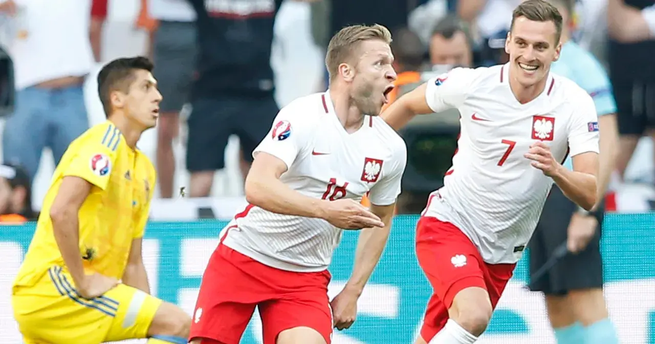 Piłkarze Polski świętują zwycięstwo nad Ukrainą na Euro. Radość na twarzach, biało-czerwone barwy.