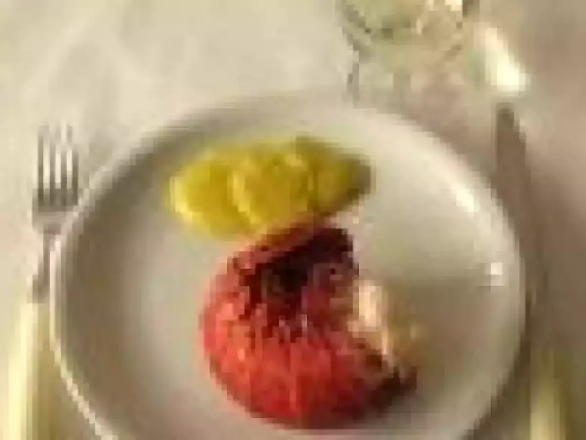 Une langouste rouge sur une assiette blanche avec des tranches de citron. On se demande : peut on manger les œufs de langouste ?
