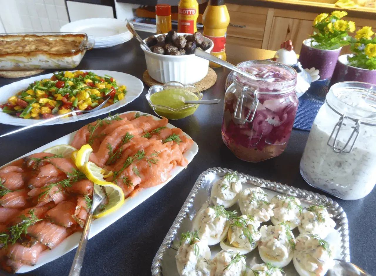 Ett härligt påskbord med mat som gravad lax, köttbullar, sill och ägghalvor.