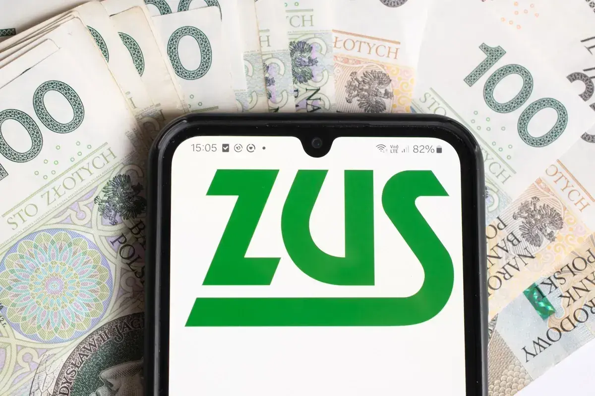 Telefon z logo ZUS na tle banknotów 100 zł. Sprawdzam, do kiedy ZUS.