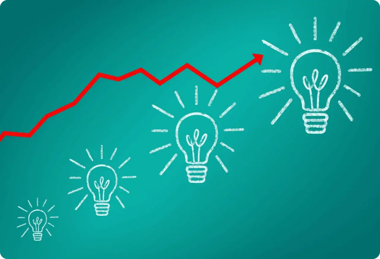 Gráfico de línea roja ascendente sobre bombillas de luz, simbolizando el crecimiento de **herramientas inteligentes** y la innovación.