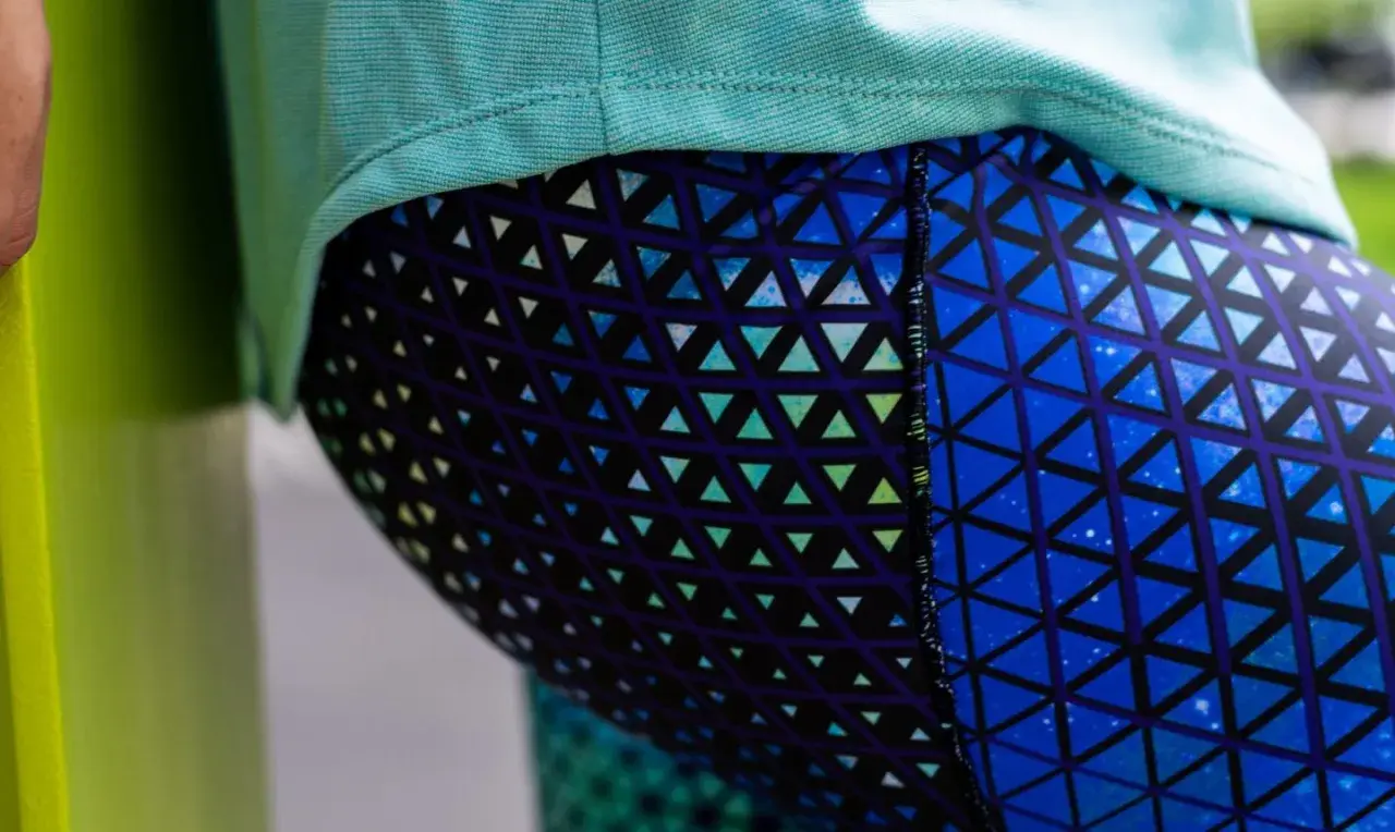Close-up of a person wearing blue leggings with a geometric triangle pattern. This image could be part of a tutorial on how to sew leggings.