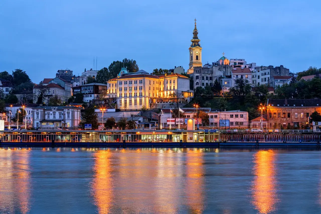 Wieczorny widok na Belgrad, Serbię, z rzeką i oświetlonymi budynkami. Warto zobaczyć w Serbii!