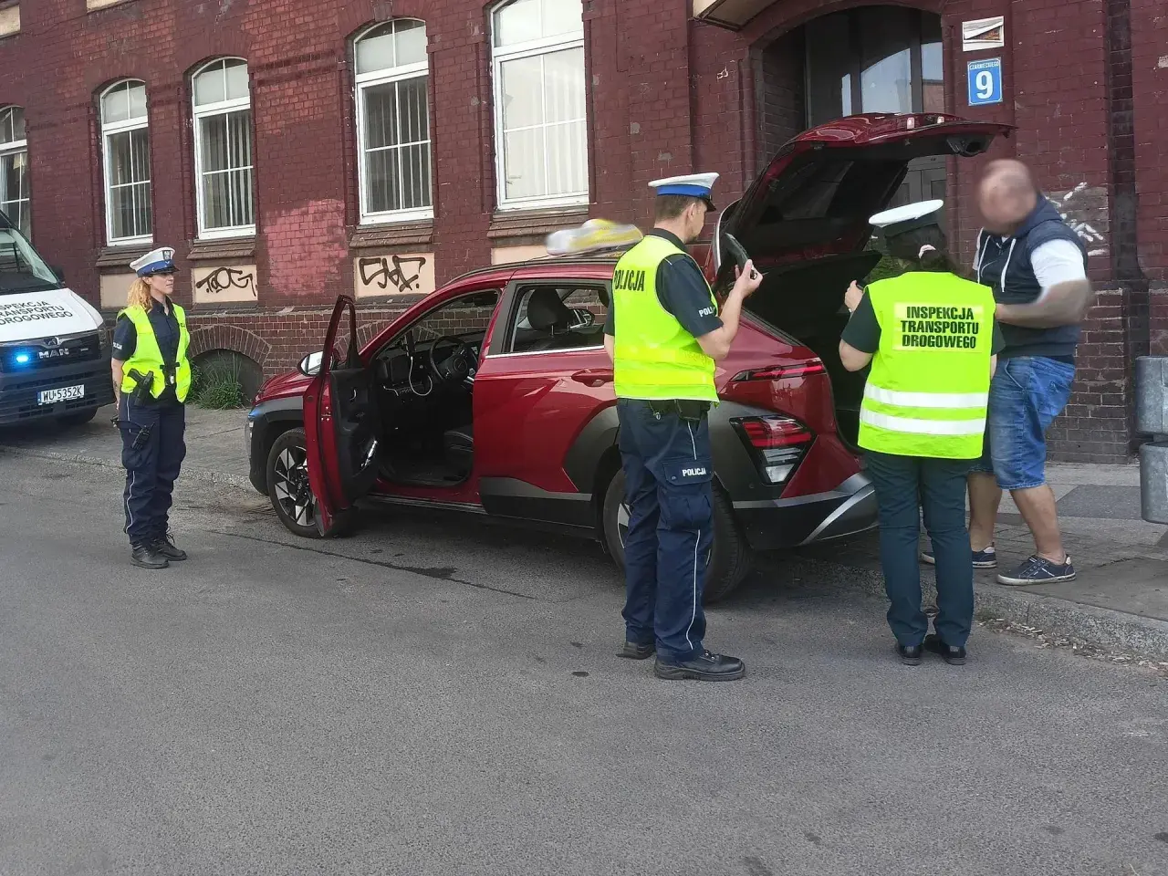 Policjanci z Inspekcji Transportu Drogowego kontrolują samochód. Czy polska policja jest zarejestrowana jako firma w USA? To pytanie pozostaje bez odpowiedzi.