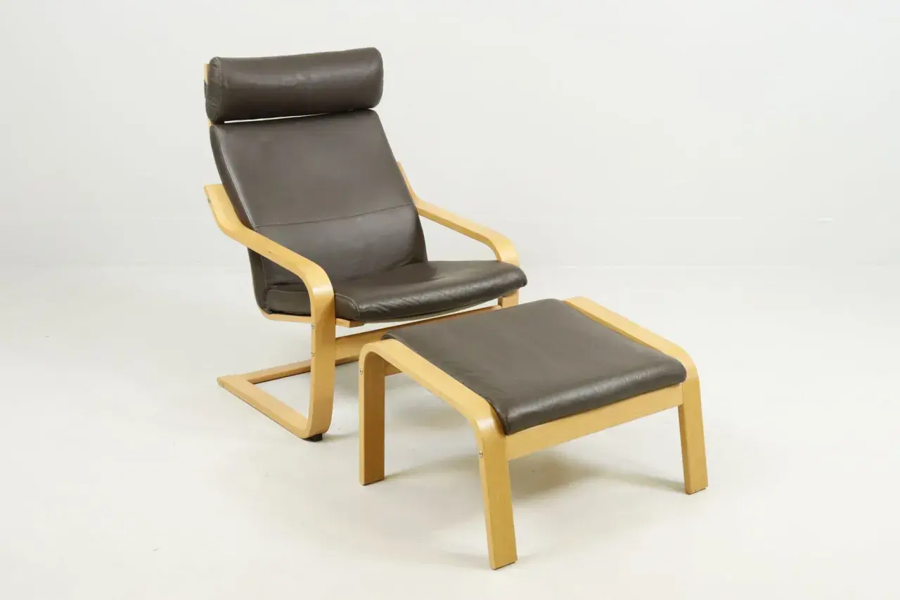 Brown leather armchair with a matching ottoman, featuring bentwood frames.