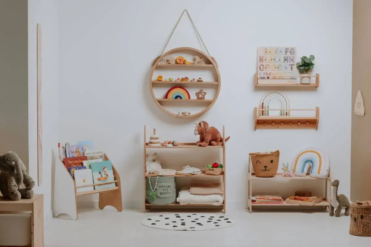 A serene nursery showcasing Montessori organization at home. Wooden shelves display books, toys, and soft blankets, creating a calm and inviting space for a child.