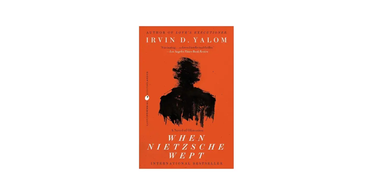 Okładka książki "Gdy Nietzsche płakał" Irvina D. Yalom z czarną sylwetką na pomarańczowym tle.