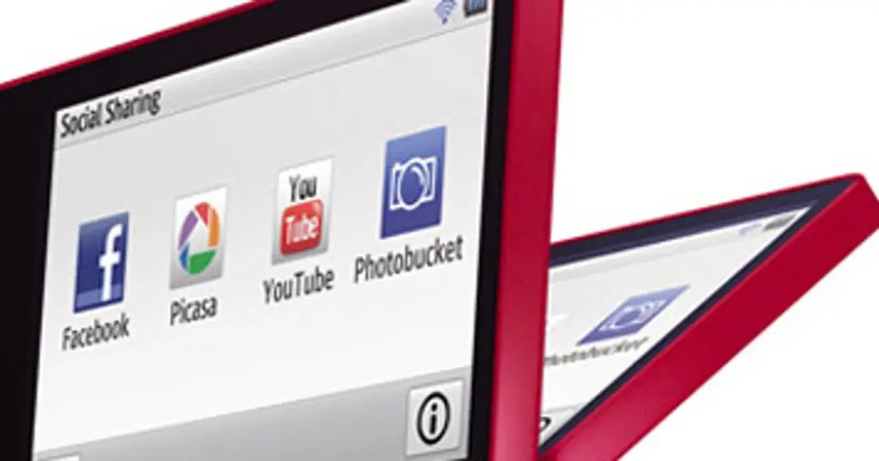 Czerwony aparat Samsung MV900F z ekranem pokazującym ikony Facebooka, Picasy, YouTube i Photobucket.