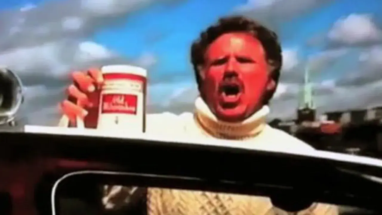 Will Ferrell med solbränd hy och vit polotröja håller upp en burk Old Spice.