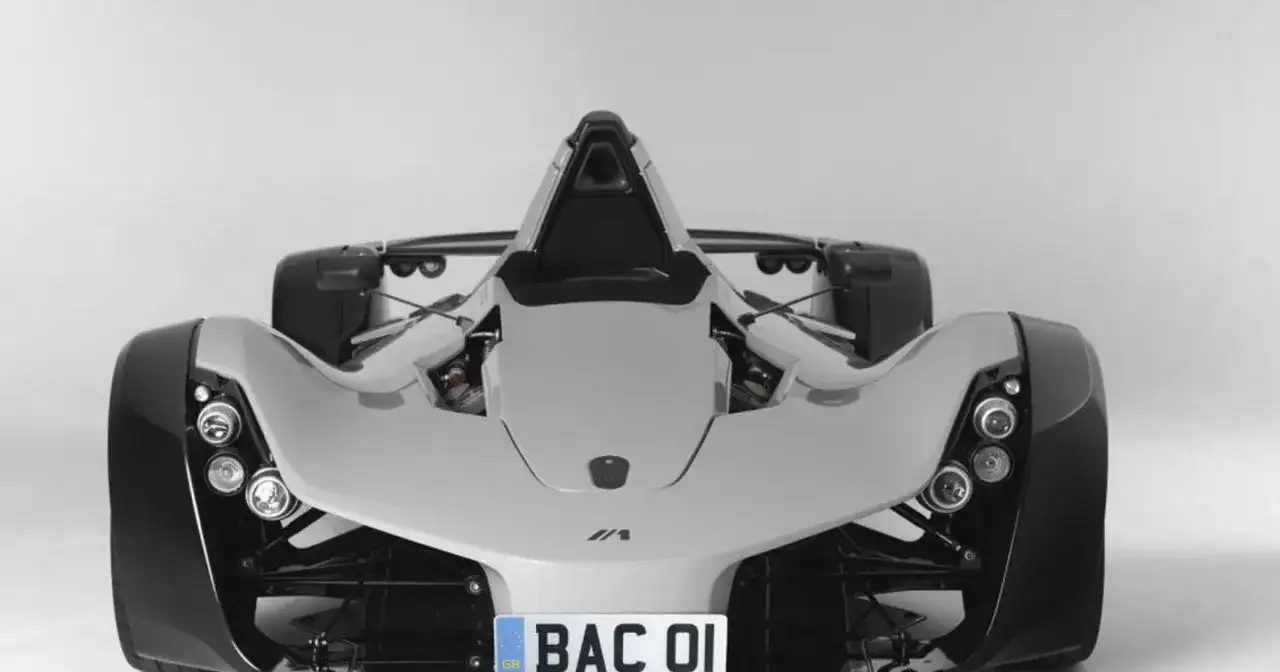 Biały, sportowy samochód BAC Mono z widocznym silnikiem i tablicą rejestracyjną "BAC 01".