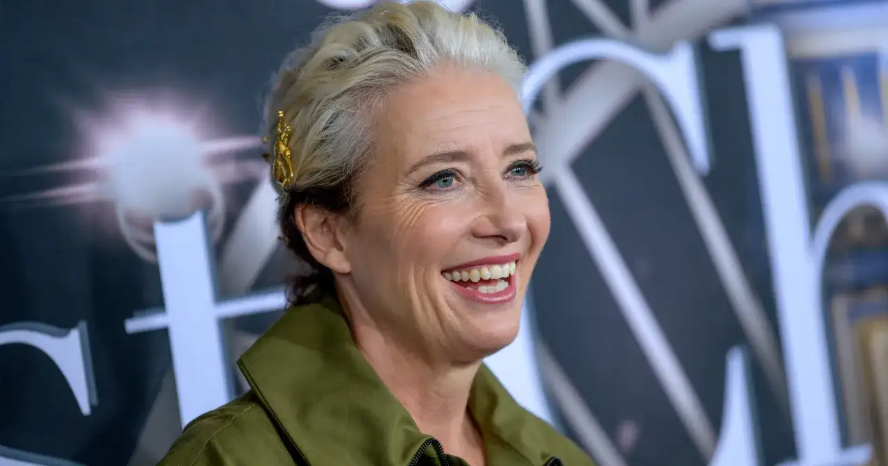 Uśmiechnięta Emma Thompson, znana z wielu wspaniałych filmów, z blond włosami ozdobionymi złotą spinką.