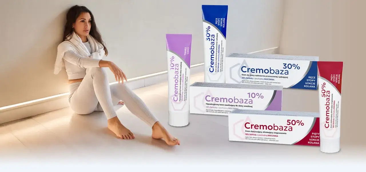 Kobieta w białym stroju siedzi obok tubek z kremami Cremobaza 10%, 30% i 50%.