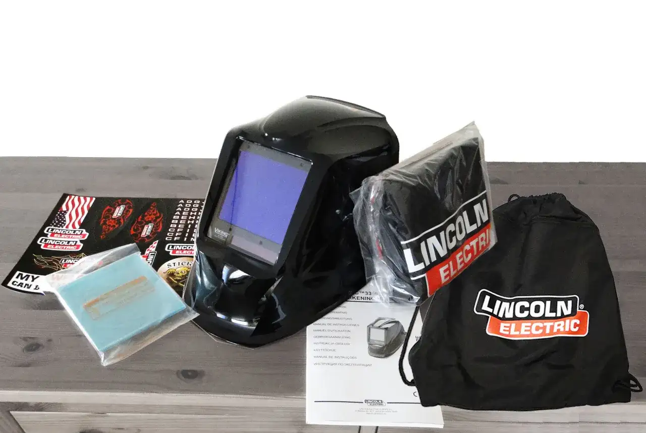 Zestaw zawiera czarną maskę spawalniczą Lincoln Electric, worek, instrukcję i naklejki.