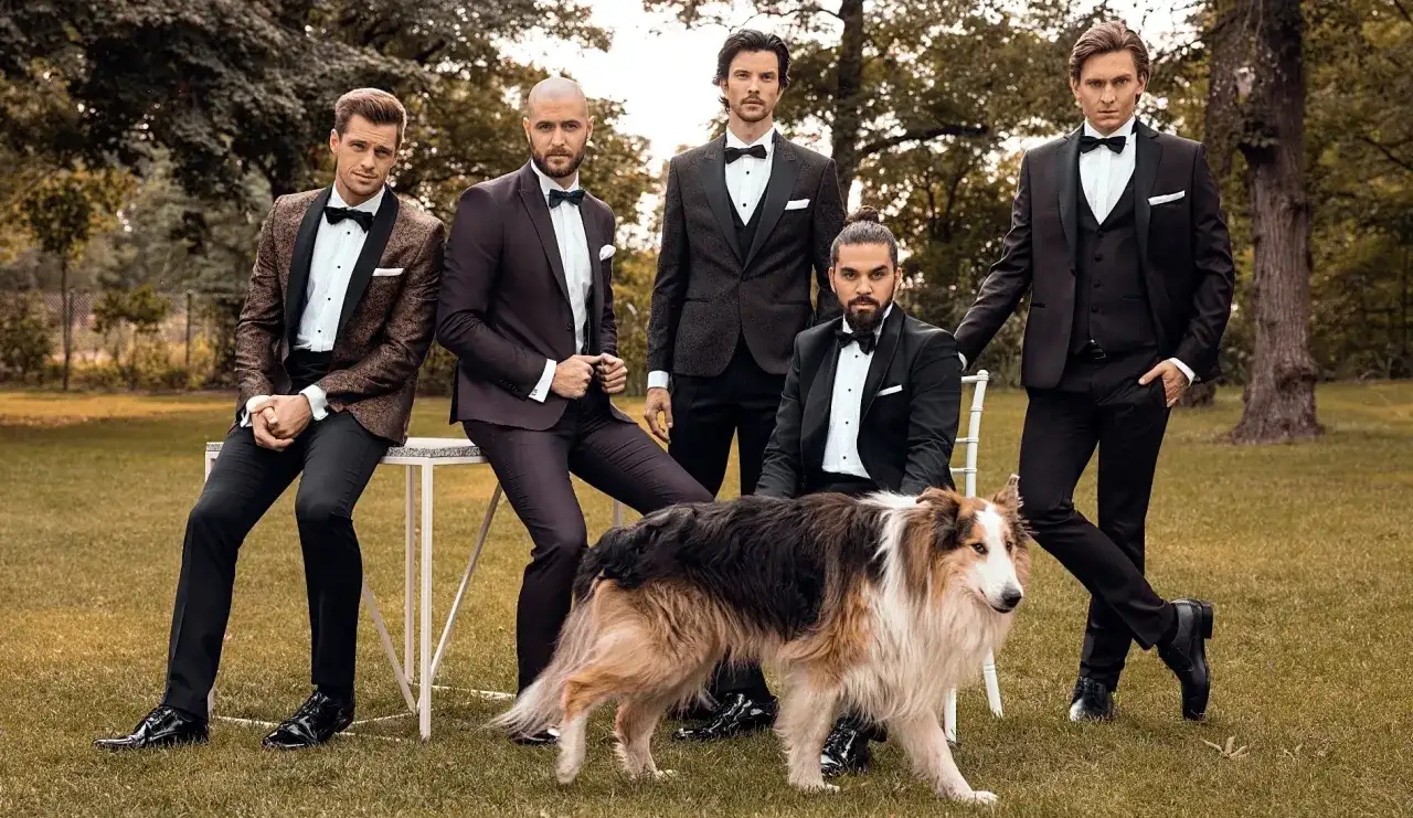 Eleganccy panowie w smokingach i stylowe buty do smokingu, towarzyszy im pies.