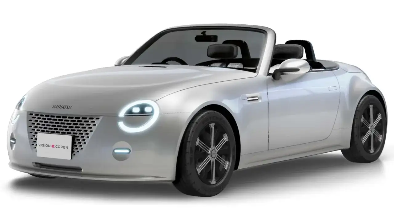 Srebrny kabriolet Daihatsu Vision Copen z okrągłymi światłami i sportowymi felgami.