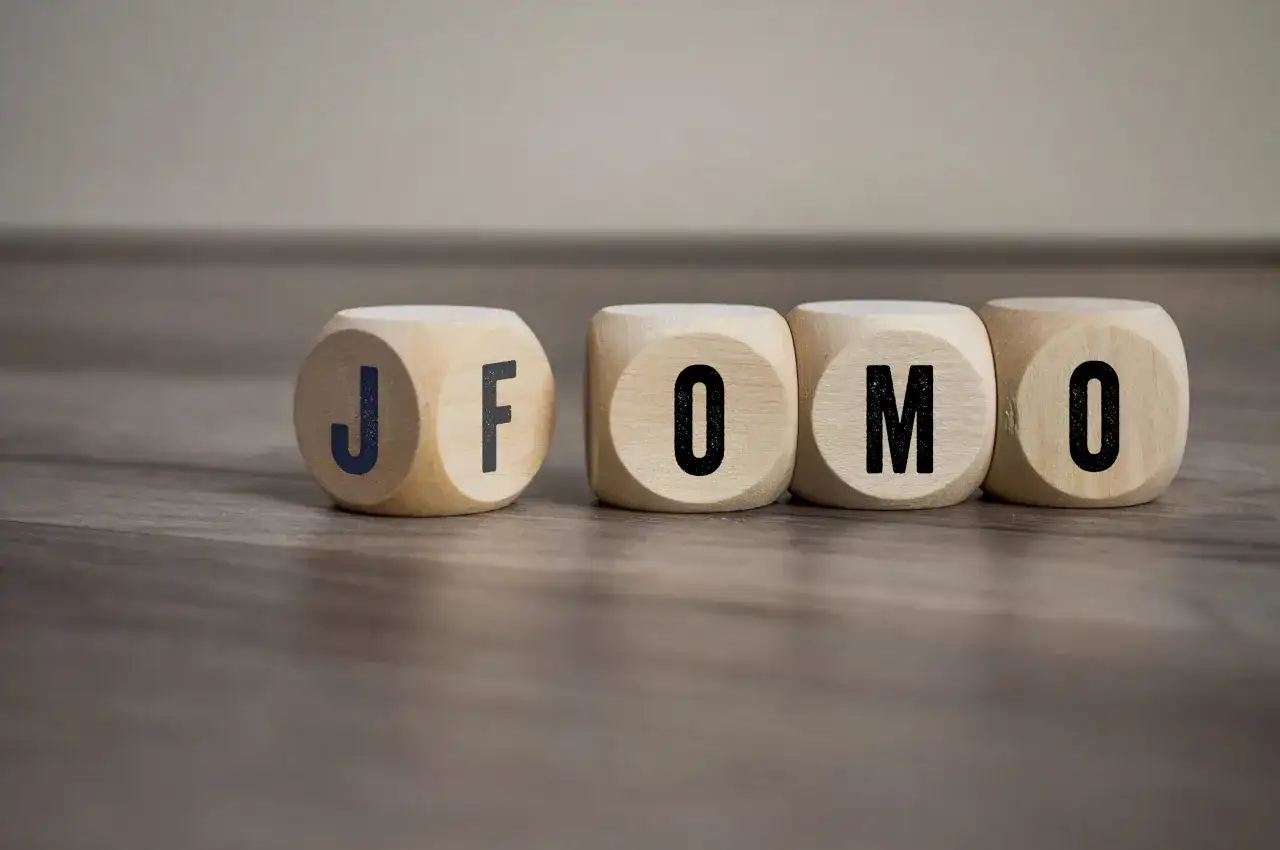 Drewniane kostki z literami J, F, O, M, O. Czy to FOMO? Strach przed tym, że coś nas omija.