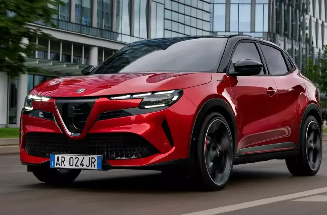Czerwony SUV Alfa Romeo na drodze, jeden z najlepszych SUVów, z nowoczesnym designem i sportowym charakterem.