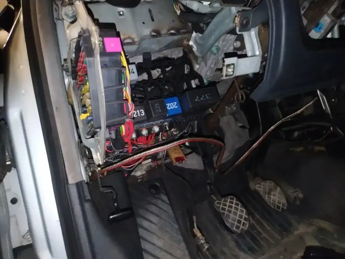 Audi A4 B6 bezpieczniki pod maską. Widoczne przewody i skrzynka z bezpiecznikami, przygotowanie do naprawy.