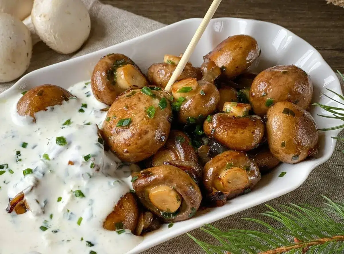 Gebratene Champignons mit cremiger Sauce und Schnittlauch – ein einfaches Gericht, das zu vielen Champignons Rezepten passt.