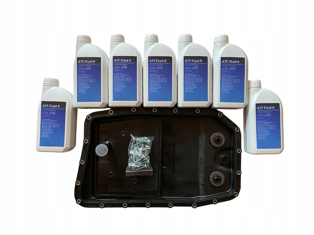 Butelki z płynem ATF i miska olejowa skrzyni biegów.