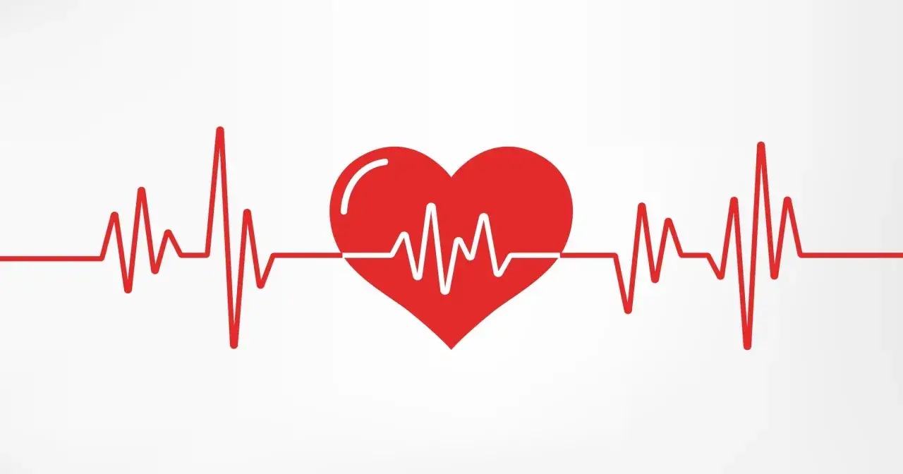 Czerwone serce z linią EKG na białym tle.