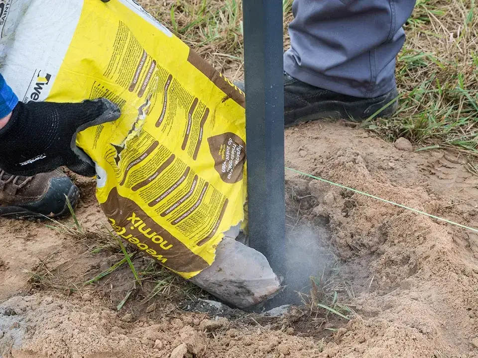 Jak zrobić zaprawę pod słupki ogrodzeniowe – skuteczne przepisy i porady
