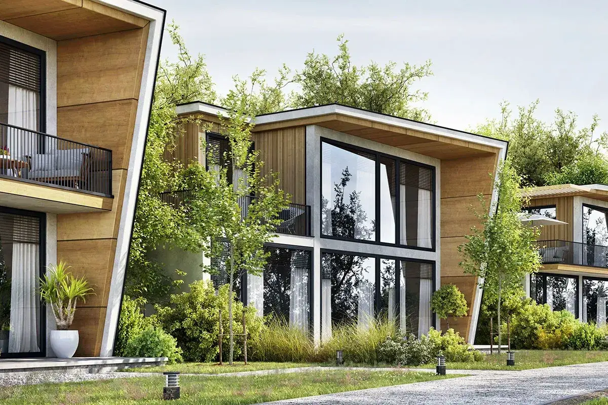 Super nowoczesne domy z drewnianymi elementami i dużymi przeszkleniami, otoczone zielenią.
