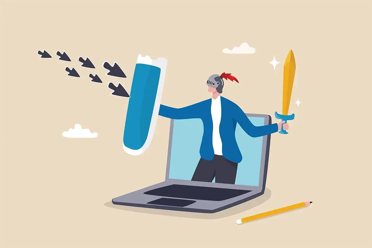 Rycerz z tarczą i mieczem broni się przed strzałkami wychodzącymi z laptopa, symbolizującymi niebezpieczeństwa w internecie.