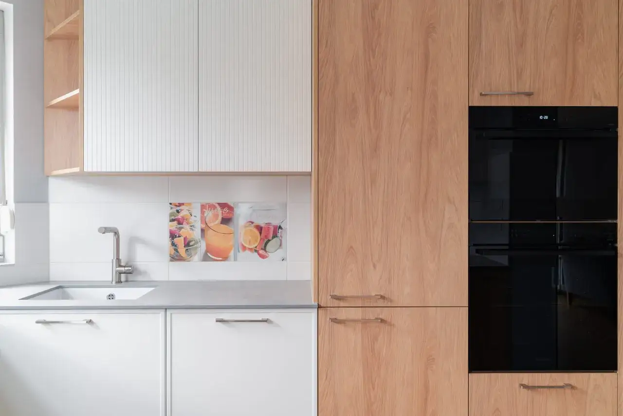 Nowoczesna kuchnia z białymi frontami i drewnianymi elementami. Decyzja: fronty lakierowane czy akrylowe? Wybór należy do Ciebie!