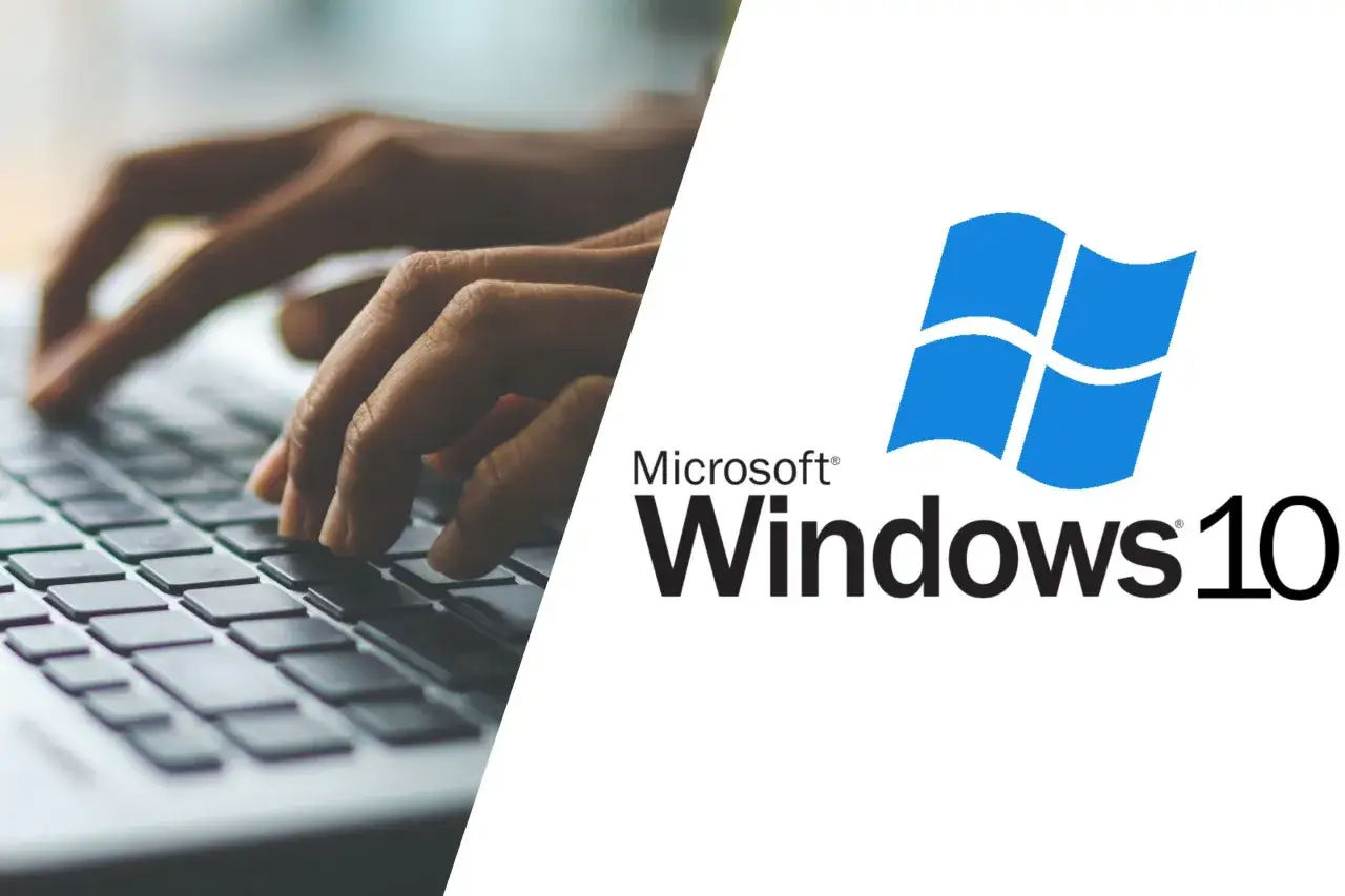 Dłonie piszą na klawiaturze laptopa obok logo Windows 10. Dowiedz się, windows 10 do kiedy wsparcie.