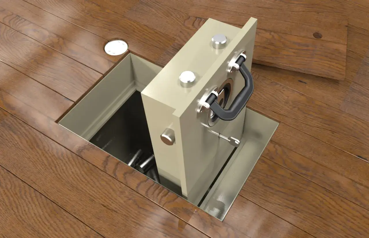 Jak zamontować sejf w ścianie? Widok z góry na sejf wbudowany w drewnianą podłogę, z widocznym wnętrzem i kluczykiem.