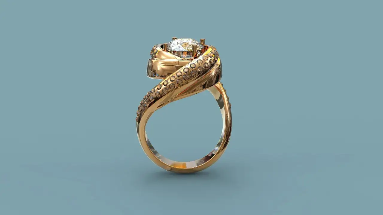 Złoty pierścionek z brylantem i wysadzanym kamieniami pasmem.
