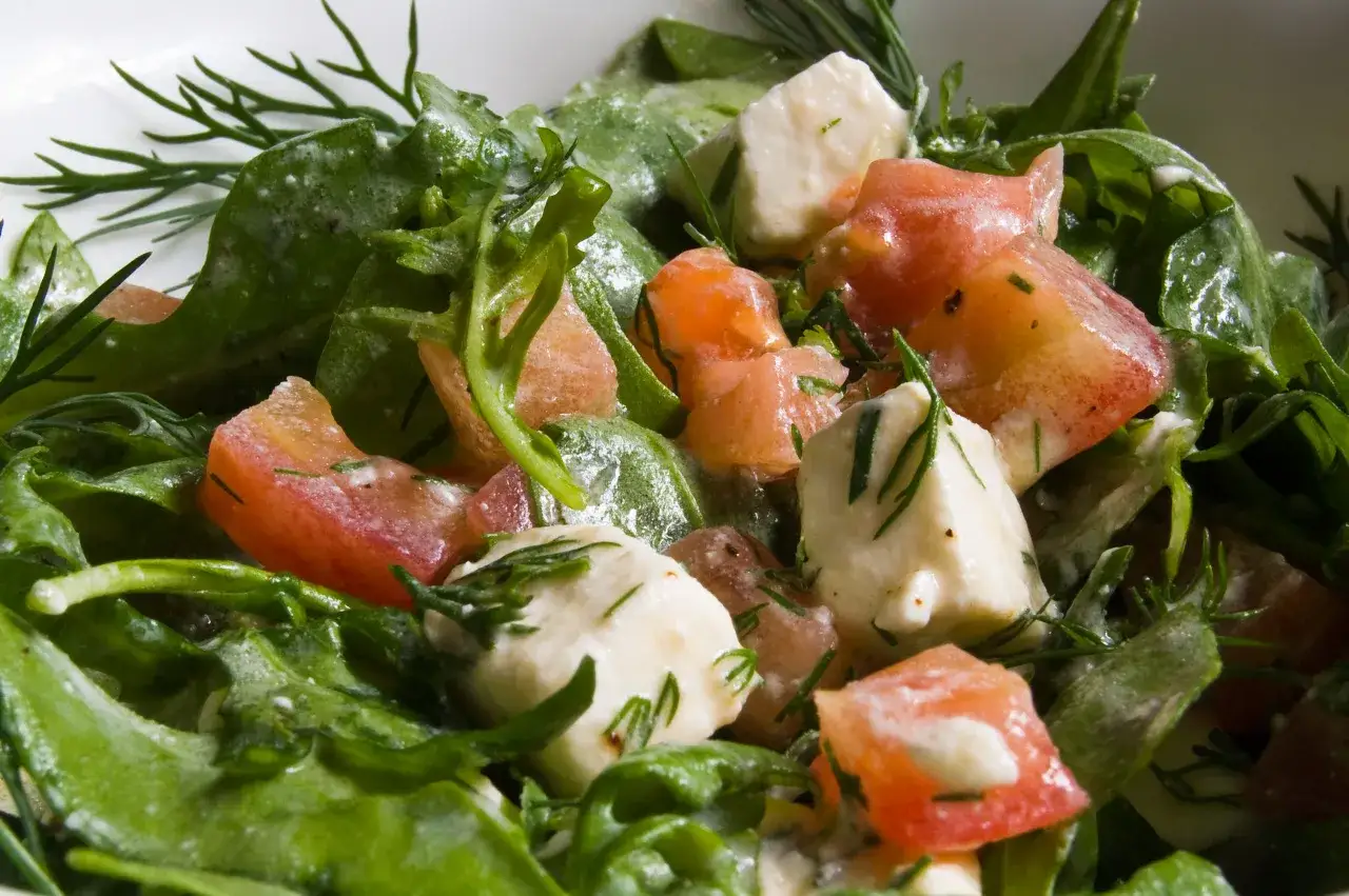 Sałatka z rukolą i fetą i pomidorkami koktajlowymi, z dodatkiem świeżego koperku.